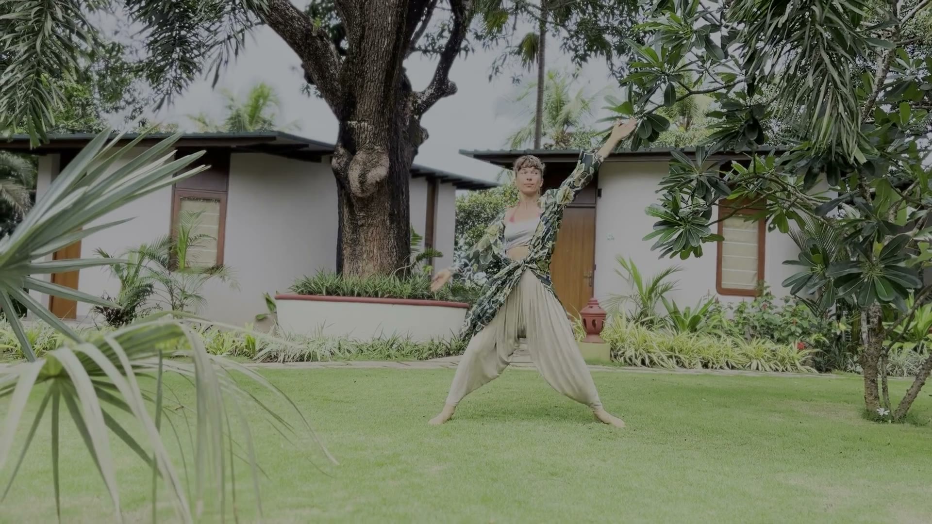 Lola practicing Dragon Wings movement on a balcony beside water